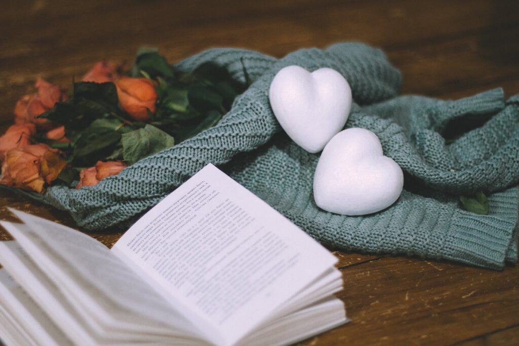 photo of white heart shapes near a book
