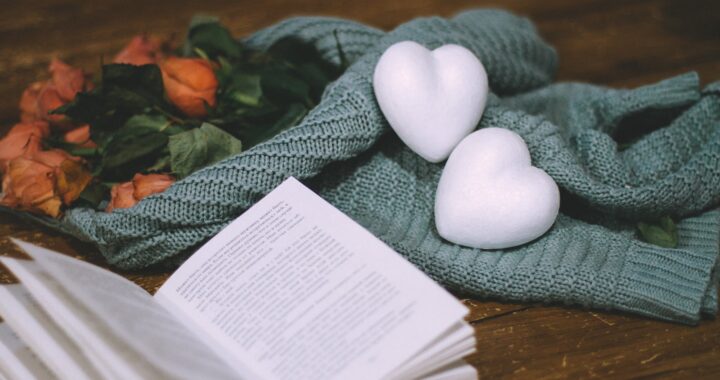 photo of white heart shapes near a book