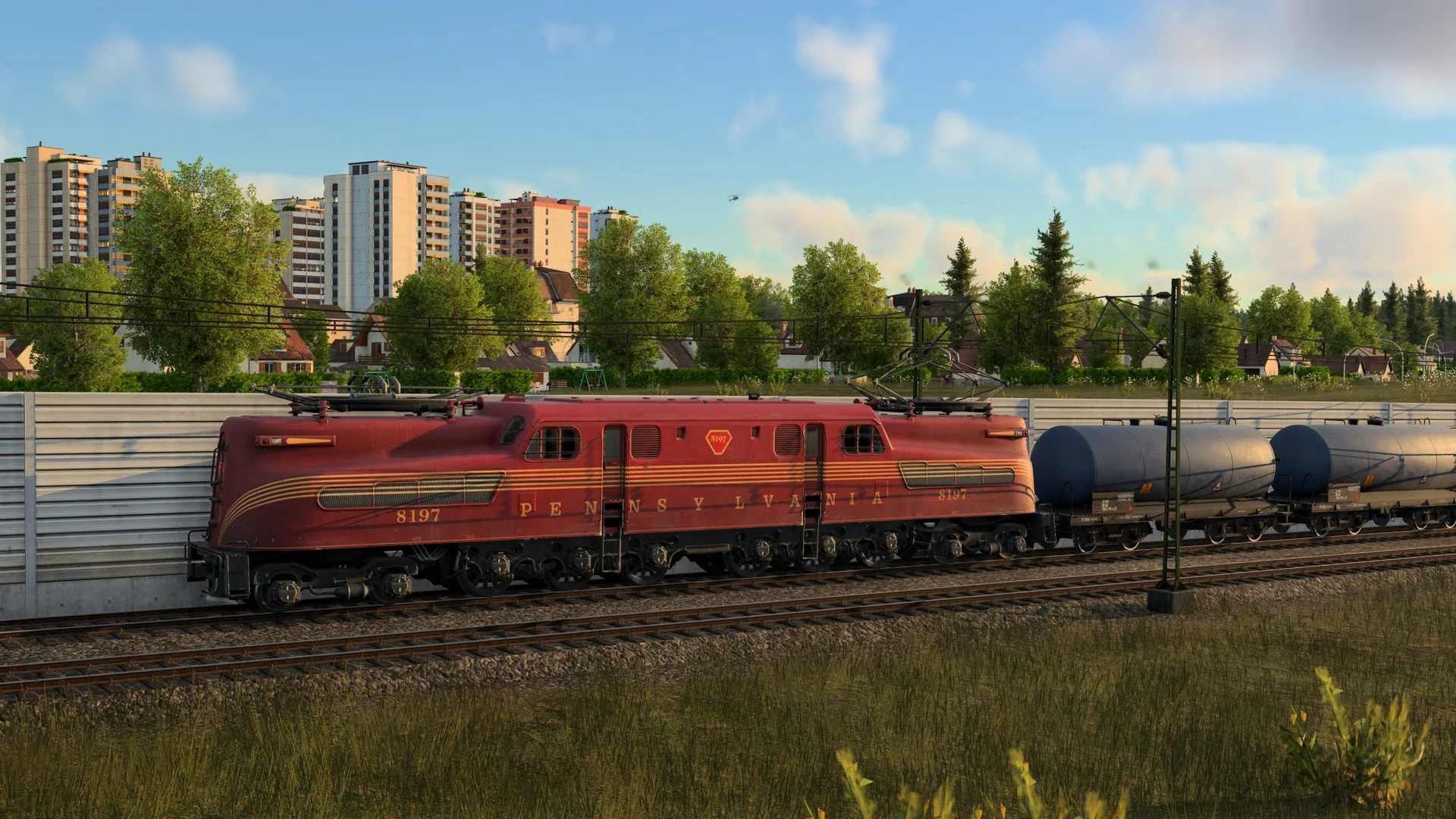 Locomotiva elettrica contemporanea trainante una lunga fila di cisterne petrolifere attraverso paesaggi collinari in Transport Fever 3